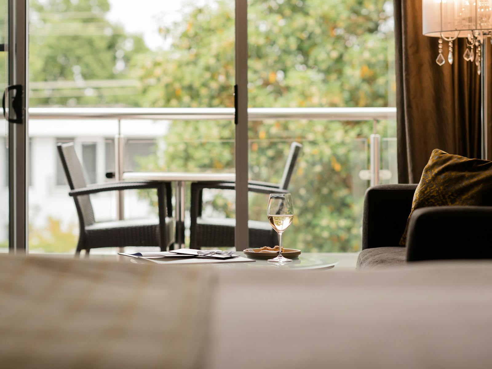 Beautifully appointed king suite looking over balcony to treetops at the Gateway